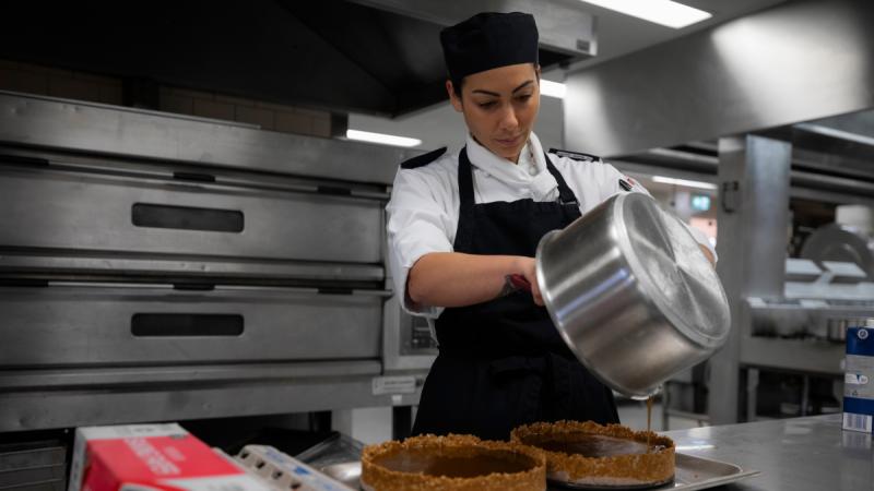 Aircraftwoman Natasha Sharma prepares food during her initial employment training at HMAS Cerberus, Victoria. 