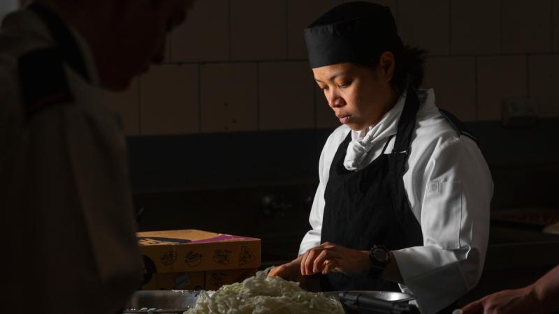 Aircraftwoman Cindy Cao prepares food during her initial employment training at HMAS Cerberus, Victoria. 