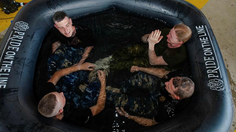 RAAFSFS fire training students take an ice bath after conducting firefighting training – a measure of recovery and rehabilitation introduced by the HPO team. 