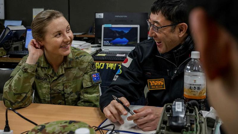  Corporal Caitlin Arthurson speaks to her Japanese counterpart regarding gender, peace and security matters during Exercise Yama Sakura 85. 