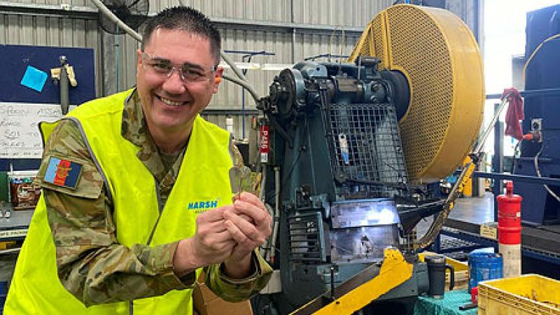 Captain Andre Borg with brand new field ration eating devices (FREDS) at the manufacturing workshop in Queensland.