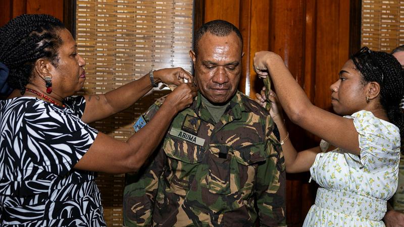 Deputy Commander of 3rd Brigade Colonel Boniface Aruma being promoted by his wife, Cynthia Aruma and daughter, Hannah Aruma at the Army Museum North Queensland, Townsville. 