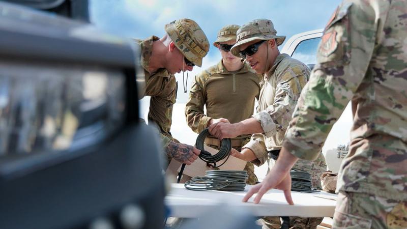 Explosive Ordnance Disposal Technicians from the Royal Australian Air Force (left) and United States Air Force (right) prepare explosive time fuses during a rapid explosive hazard mitigation scenario in the lead up to Exercise Cope North 2024, at Northwest Field, Guam.