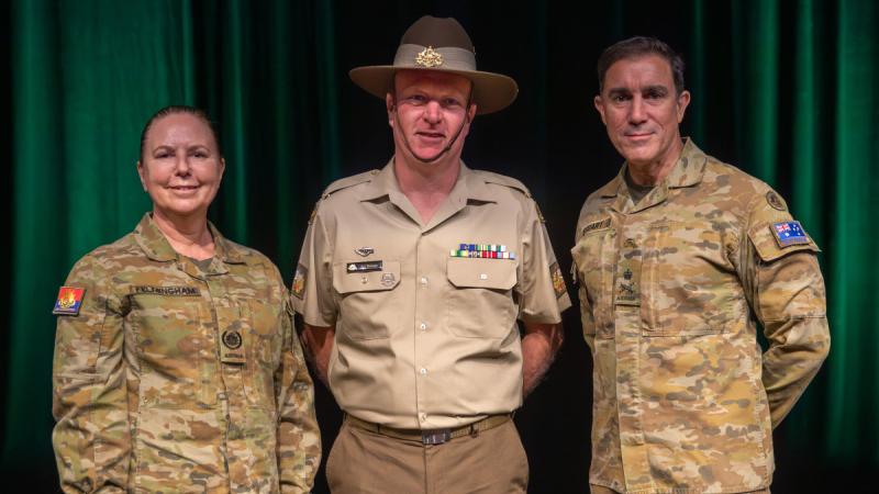 Chief of Army Lieutenant General Simon Stuart, right, and Regimental Sergeant Major of Army Warrant Officer Kim Felmingham, left, present Warrant Officer First Class Andrew Beaman with his advancement to Tier-C. 
