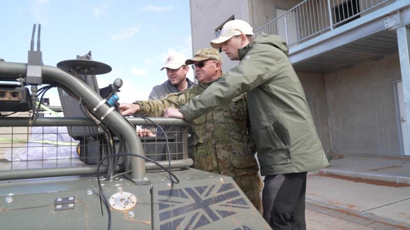 Personnel discuss the next steps during a Trusted Operation of Robotic Vehicles in a Contested Environment (TORVICE) trial.