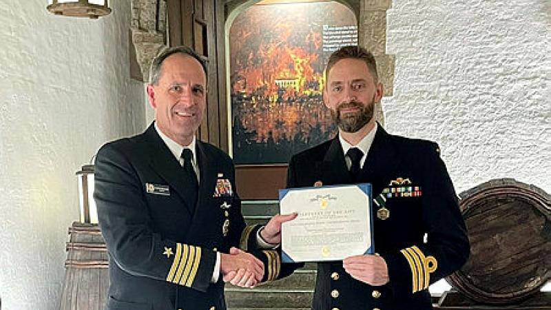Rear Admiral Reifsteck, United States Navy, presents Commander Daniel McCall, Royal Australian Navy, with a citation which accompanies the United States Navy and Marine Corps Commendation Medal.