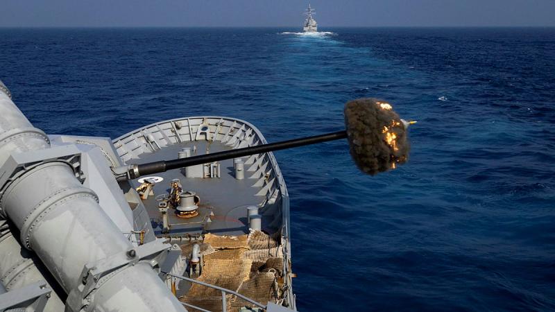 HMAS Warramunga fires its 5-inch naval gun during a joint live-firing with USS Halsey while at sea on regional presence deployment. Photos: Petty Officer Leo Baumgartner