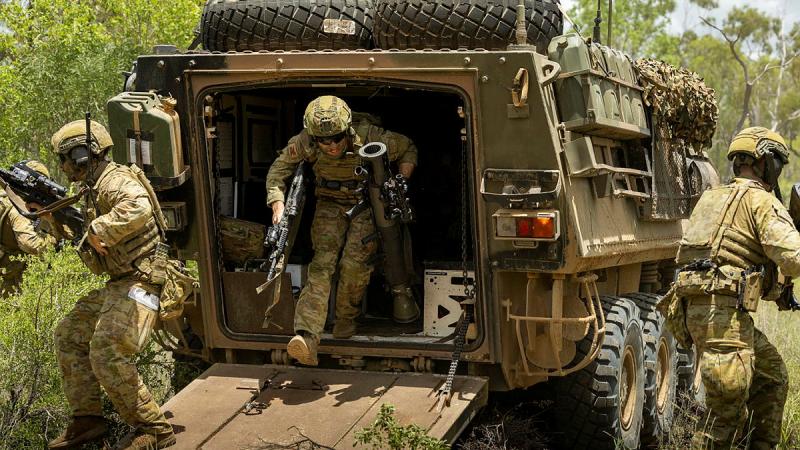 Trooper Lachlan Hinspeter from the 2nd Cavalry Regiment dismounts from an Australian light armoured vehicle at Townsville Field Training Area, Queensland. 