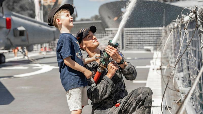 Able Seaman Peter Mason demonstrates fire fighting hose techniques onboard HMAS Arunta during Fleet Base East's open day, Sydney. 