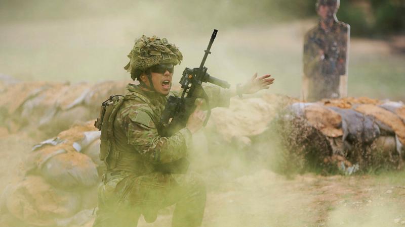 Lance Corporal Winston Li, 10th/27th Battalion, Royal South Australian Regiment, yells instructions during training at the Murray Bridge Training Area, South Australia. 