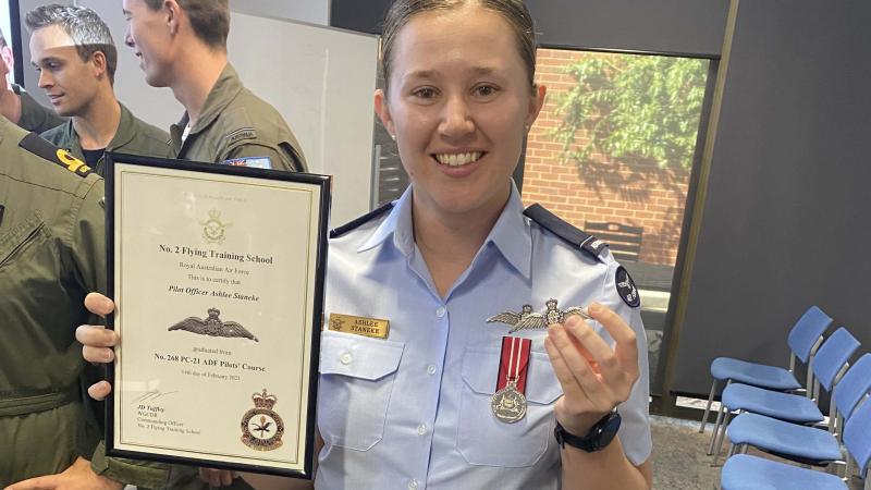 Pilot Officer Ashlee Staneke holding her graduate certificate from 268 PC-21 ADF Pilots’ Course last year.