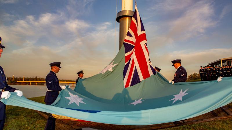 Royal Australian Air Force (RAAF) personnel from the Australia’s Federation Guard raise the RAAF Ensign during a flag raising ceremony at Regatta Point, Canberra to celebrate the RAAF's 98th Anniversary.