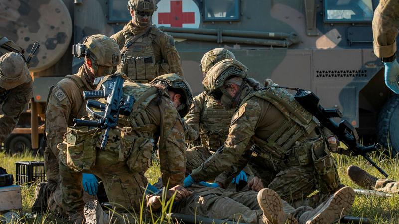 Medics from 2 Health Battalion simulate rendering first aid to a soldier during a mass casualty exercise in Shoalwater Bay training area, Queensland, in 2023. Photo: Corporal Nicole Dorrett