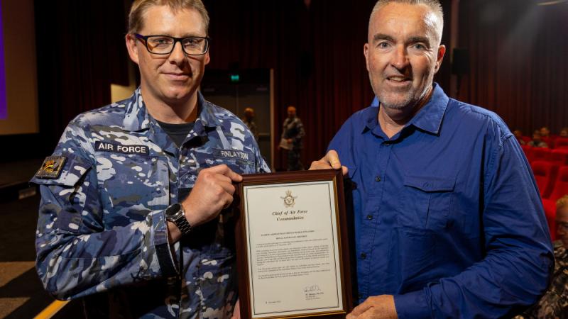 Leading Aircraftman Thomas Finlayson (L) is awarded a Gold Commendation for providing first aid assistance to Mr Jeff Goodwin (R), during the Warrant Officer of the Air Force visit to RAAF Base Richmond.