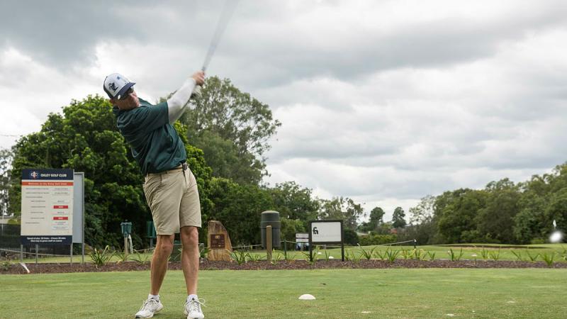 Retired Navy Captain Michael Beard hits a tee-off during the HMAS Moreton Annual Navy Week Golf Day. 