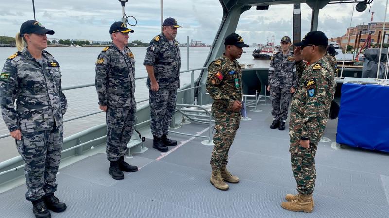 Timor Leste Defence Force Lieutenant Jacinto Do Nascimento salutes Lieutenant Clementino Colo ahead of his promotion aboard PT Paluma. 