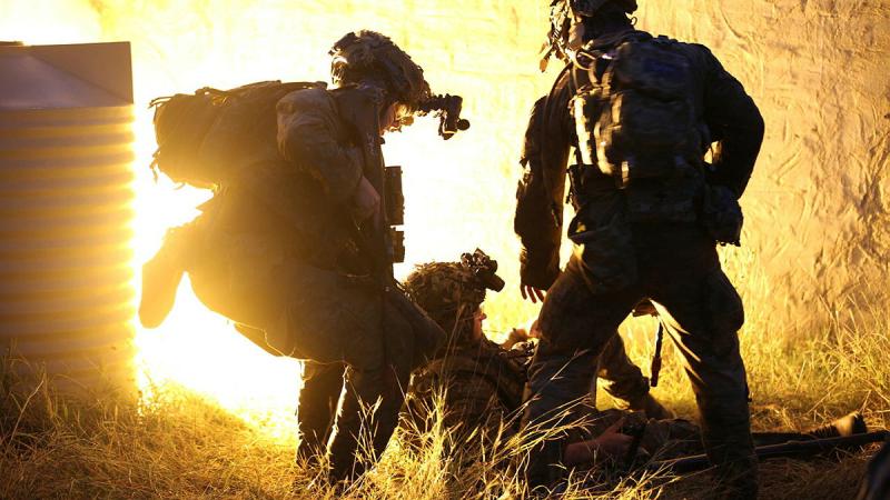 A 3rd Combat Engineer Regiment soldier assists a simulated casualty during an urban breaching exercise at Townsville Field Training Area.
