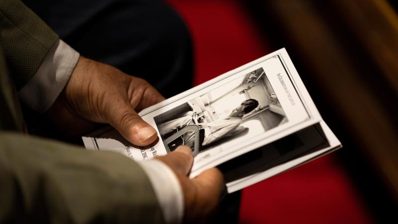 An attendee of the naval ceremonial funeral service to former Chief of Naval Personnel Rear Admiral (retd) Guy Griffiths, held at the Garden Island Chapel, HMAS Kuttabul, NSW. 