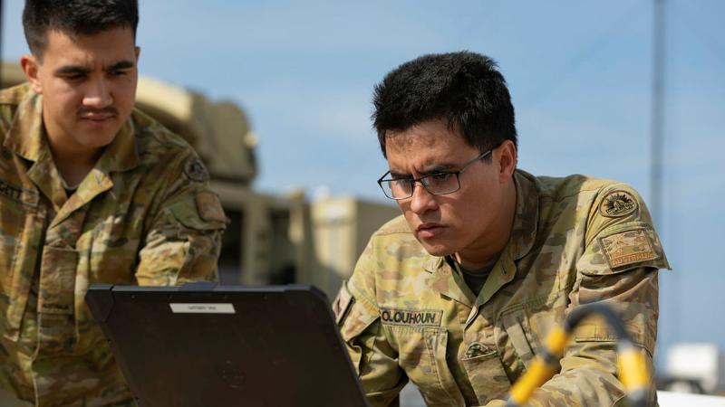 Signallers Harley Leggett and Lachlan Colquhoun set up a communications tower during Project Convergence Capstone 4 at Camp Pendleton, California in March 2024.