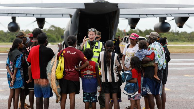 Air Force aviator Corporal Kate Kershaw, of 37 Squadron, delivers a pre-flight safety brief to residents of Borroloola prior to evacuation to Darwin via a C-130J Hercules. 
