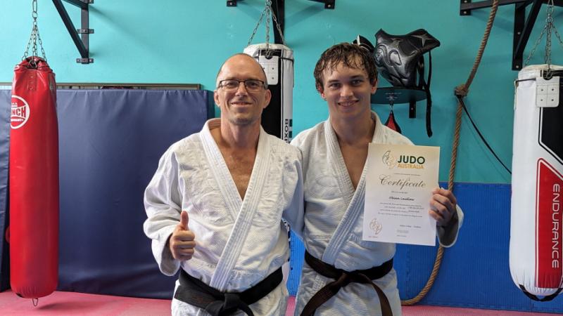 Army soldier Private Charles Laidlaw, of 2nd Health Battalion, with his son Private Obian Laidlaw in their local gym after Obian was awarded his brown belt. 