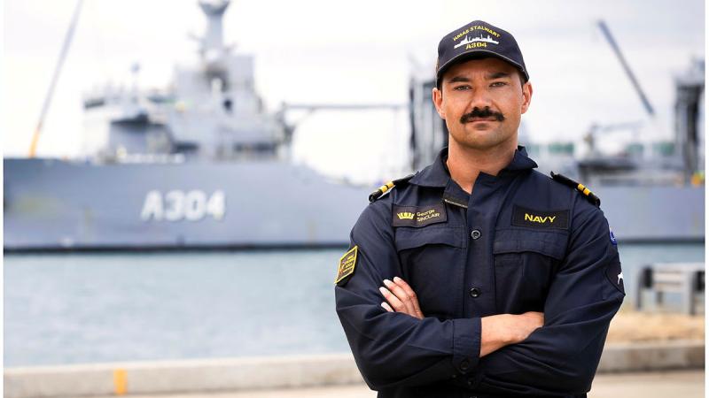 Royal New Zealand Navy Lieutenant George Sinclair in front of HMAS Stalwart at Fleet Base West in Perth, WA.