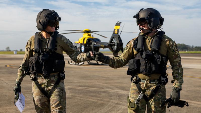 Australian Army helicopter pilot Lieutenant Nicole Ravell and aircrew operator Corporal Corren James from 723 Squadron, on the flight line at HMAS Albatross.