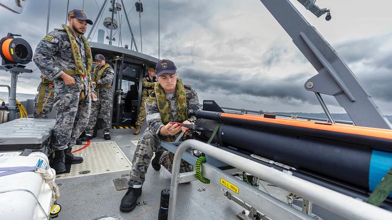 Combat Systems Operator Mine Warfare Able Seaman Grayden Ash inspects the SeaFox expendable mine neutralisation system onboard a mine countermeasure support boat during Exercise Dugong.