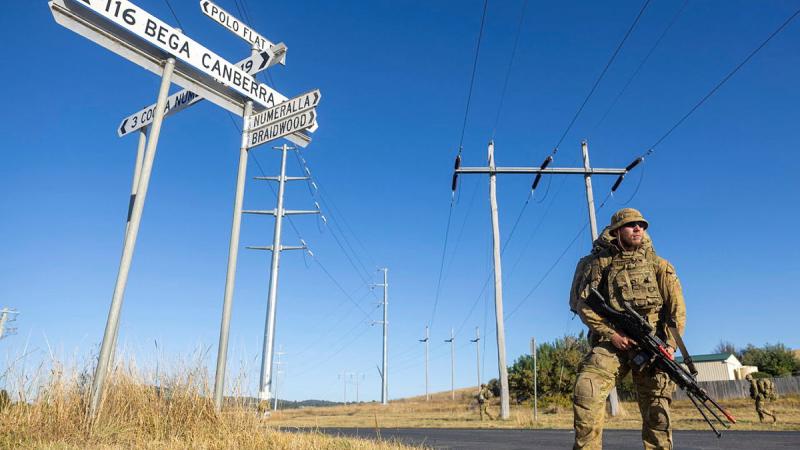 Royal Military College - Duntroon Royal Australian Air Force Staff Cadet Samuel McMahon patrols a country road during an urban operations course in Cooma, NSW. 