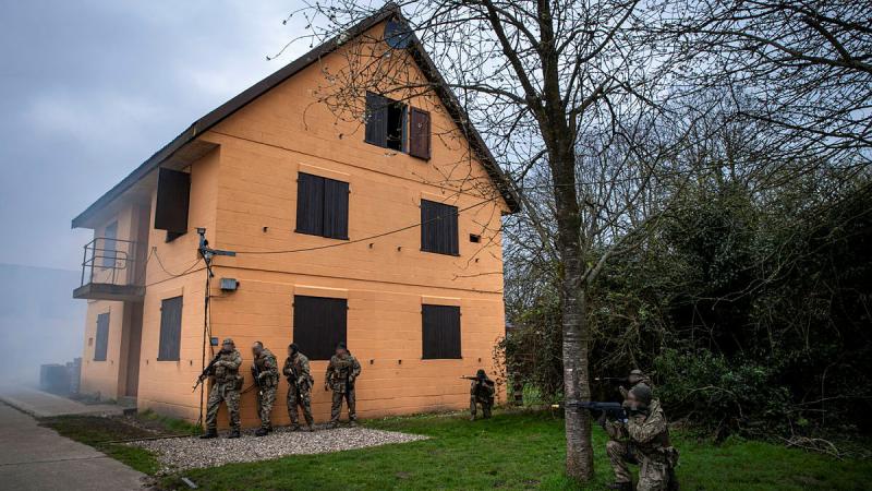 Caption: Armed Forces of Ukraine personnel perform an urban assault as part of the Platoon and Company Sergeants Battle Course run by Australian Army soldiers deployed on Operation Kudu in the United Kingdom. Photo: Corporal Nicole Dorrett