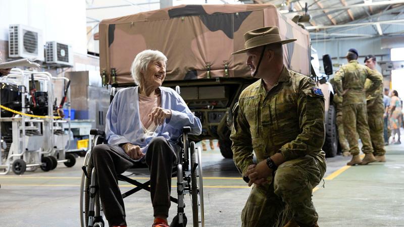 Craftsman Travis Cooper speaks with World War II veteran Ms Peggy Martin in the 13th Combat Service Support Battalion workshop during her visit to Irwin Barracks, Perth.