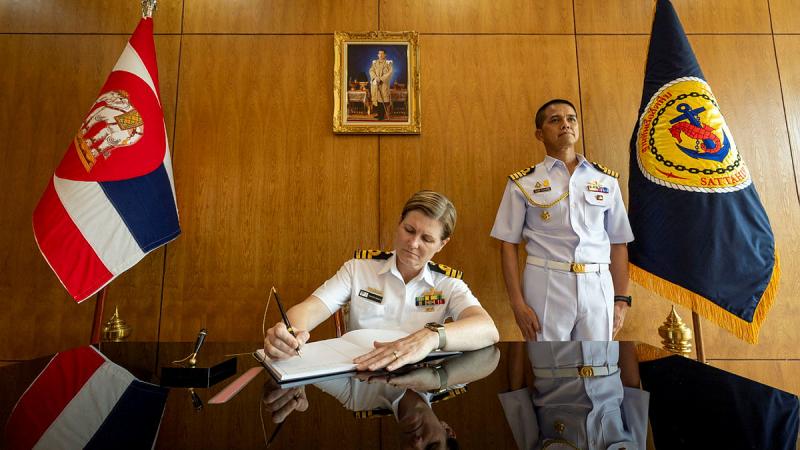 Commanding Officer HMAS Warramunga, Commander Jennifer Graham signs the guest book during an official visit of Sattahip Naval Base, Sattahip, Thailand.