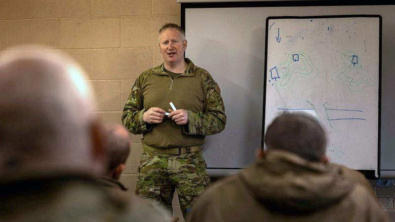 An Australian Army soldier delivers a Platoon and Company Sergeants Battle Course lesson to Armed Forces of Ukraine personnel in the United Kingdom during March for Operation Kudu. (Image has been digitally altered for security purposes.) 