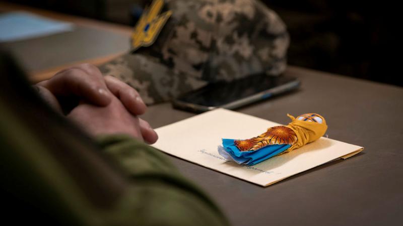 A traditional ceremonial guardian doll and handwritten letter from the Ukrainian community in Australia sits on the desk of an Ukrainian soldier attending an Australian Army lead leadership course.