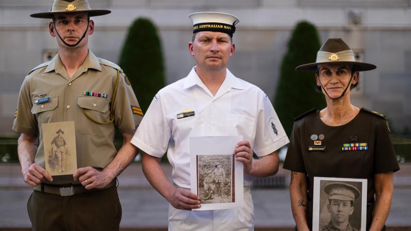 (l-r) Australia's Federation Guard Members, Corporal Michael Byrne, Able Seaman Christopher Innis and Corporal Julie Kling with photos of their relatives at the Australian War Memorial, Canberra.