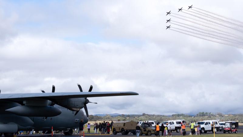 The Roulettes aerobatic display team thrills at the Canberra Airport open day with formation flying in their PC-21 aircraft over the event crowd and a C-130J Hercules. 