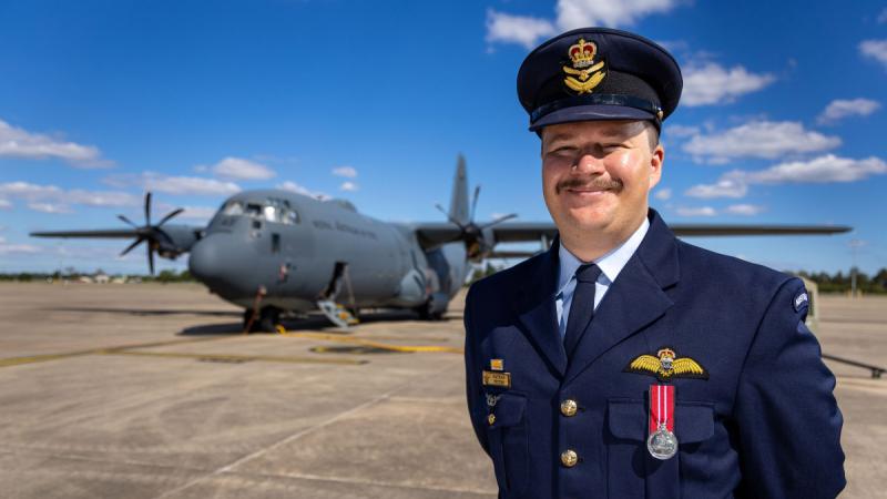 Flying Officer Nathan Peters, of 37 Squadron, in front of a C-130J Hercules during a non-flying period at RAAF Base Richmond. 