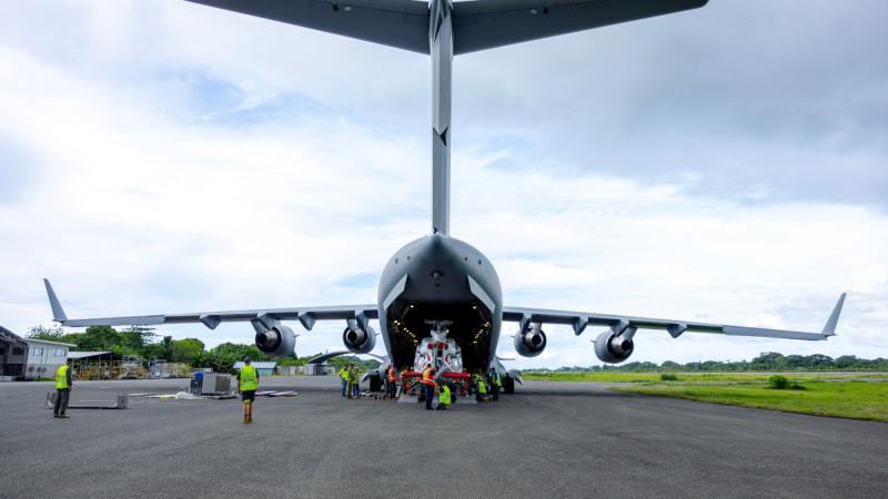 Air Force aviators deployed to Solomon Islands unload a RAAF Boeing C-17 Globemaster III at Honiara Henderson Airport. 