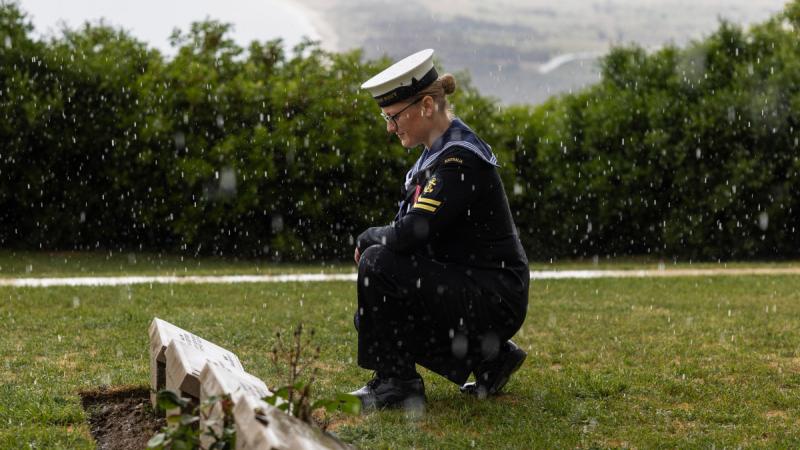 Navy sailor Leading Seaman Musician Claire Donoghue pays respect to her fallen ancestor at Walker's Ridge Cemetery on the Gallipoli Peninsula, Turkiye. 