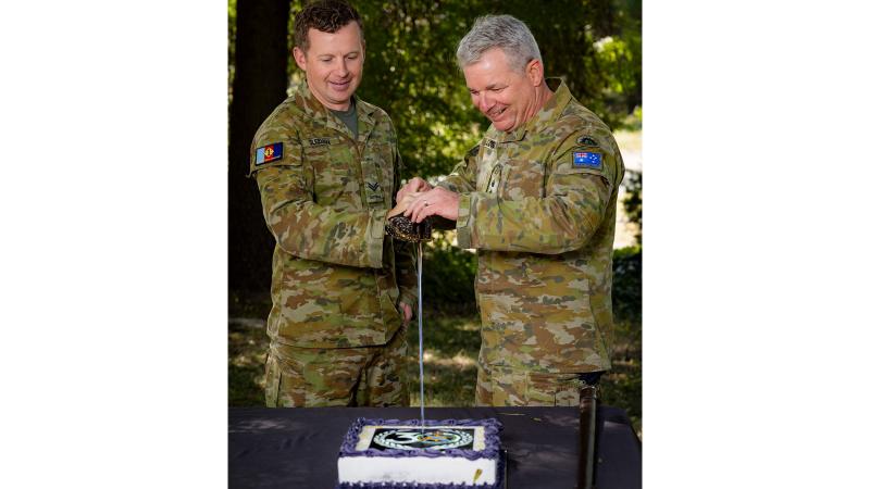 Australian Army Public Relations Service Corporal Andrew Sleeman and Head of Corps Colonel Jason Logue cut the birthday cake at 1st Joint Public Affairs Unit, Canberra, in celebration of the corps' 30th birthday. 