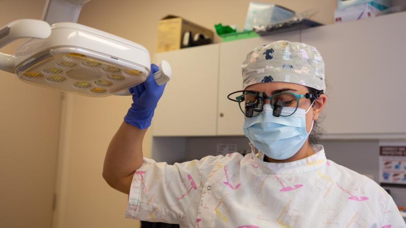 Air Force dental officer Flight Lieutenant Maryam Ferooz prepares for a dental examination during Exercise Kummundoo in Derby, Western Australia. 