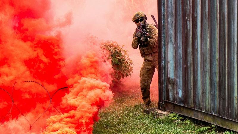 A soldier provides cover during a combat team deliberate assault at the Zhukov Urban Operations Training Facility in Malaysia during Rifle Company Butterworth 142.