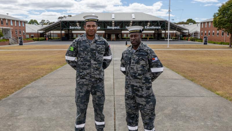 Papua New Guinea Ordinary Seaman Obadiah Orovea (left) and Stallon Kuahen (right) stand at ease in the parade ground while attending the Royal Australian Navy Recruit School at HMAS Cerberus, Victoria.