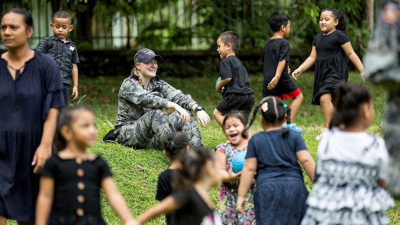 HMAS Stuart sailor Seaman Boatswains Mate Shoshana Olson engages with kids at Missionary Infant School, Samoa during a Pacific Deployment. 