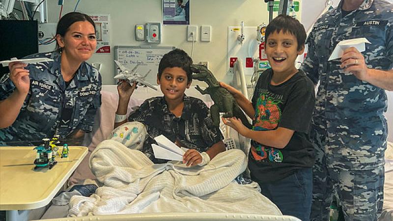 Leading Aircraftwoman Joan Domaschenz (right) and Sergeant Brett Austin visit Loka and his brother at the Queensland Children’s Hospital. 