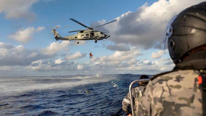 Leading Seaman Anthony "Treasure" Hunt is lowered in a lifting strop from an MH-60R Seahawk 'Valkyrie' as part of a search-and-rescue exercise during HMAS Stuart's Pacific deployment. 