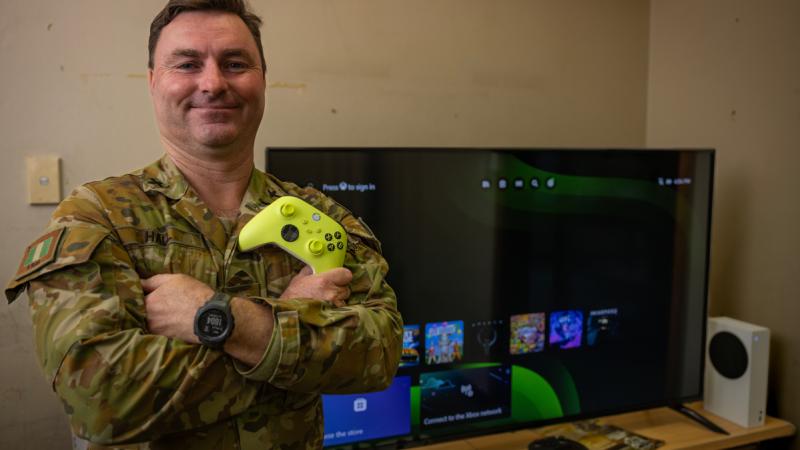 Chaplain James Hall from 6th Battalion, The Royal Australia Regiment, in the unit social gaming hub, with equipment donated by Veteran Gaming Australia, at Gallipoli Barracks.