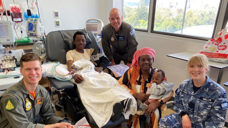 Air Force aviators from RAAF Base Edinburgh visit 16 year old Akili, and his family, in the starlight ward.