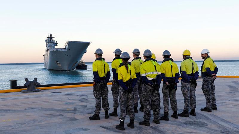 Port Services Darwin members standby as HMAS Adelaide approaches the newly built Kuru wharf at HMAS Coonawarra in Darwin, NT.