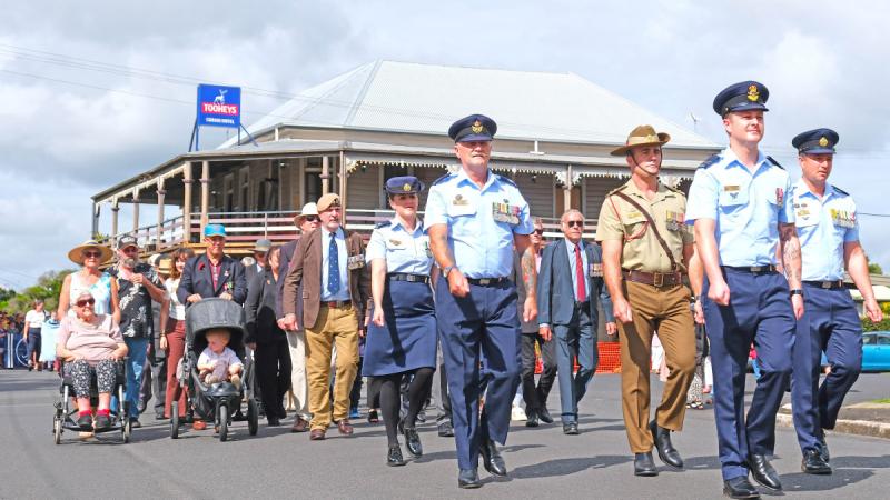 Flight Lieutenant Nathan Newby leads the Anzac Day parade down the streets of Coraki, NSW, with family members Warrant Officer Wayne Newby to his left, Flight Sergeant Jason Thomas to his right, and Corporal Tahlia Thomas.